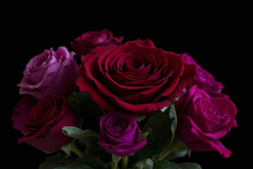 Fototapeta premium bouquet of pink roses and other flowers on a black background