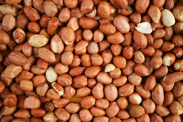 Peanut shell texture background with raw unpeeled peanuts