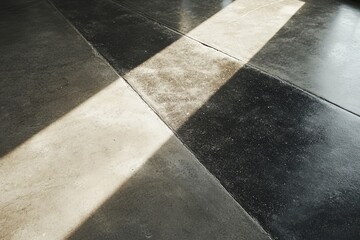 Fototapeta premium Interior concrete floor design with diagonal sunlight patterns.