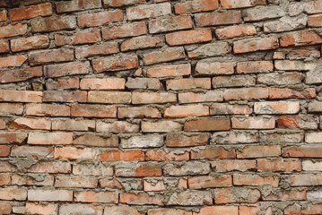 Fototapeta premium old brick wall, red and white colour, broken bricks, peeling plaster, vintage texture, background for banner, copy space