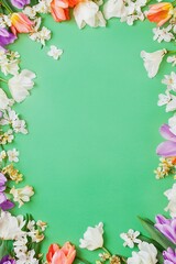 green background with colorful tulips and white flower border frame on the edges, Vertical image, copy space in the center for design. 