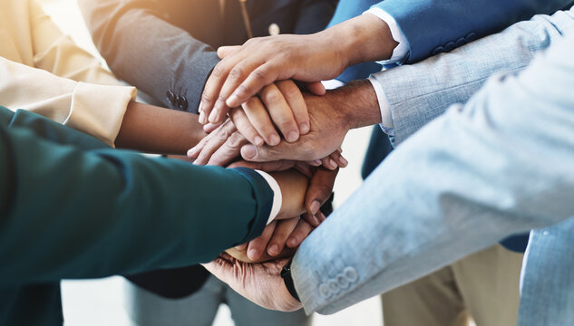 Support, team spirit and business people stack hands for cooperation, trust and goal. Group, closeup and workers huddle together for community mission, solidarity or synergy with motivation in office