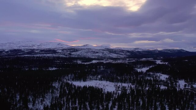Dramatic Winter Landscape of Ringebu Mountains and Dark Evergreen Forest