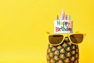 pineapple with a birthday cake and sunglasses on it