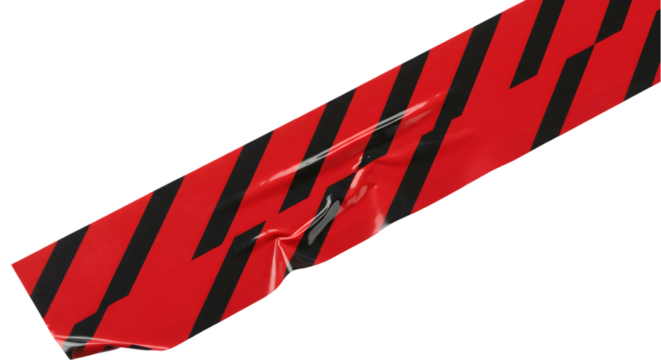 A close up of a red and black striped tape piece with creases on a black background in a diagonal angle