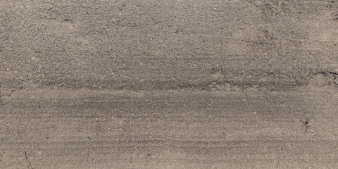 view from above on texture of asphalt road surface with cracks