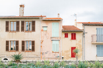 Colorful Shutters on Rustic Mediterranean Homes with Desert Plants in Foreground