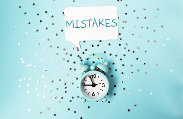 Clock with the word Mistakes written above it