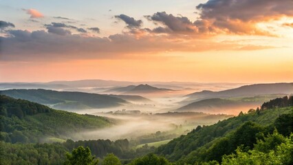 Picturesque sunrise over rolling hills with misty valleys and green forest
