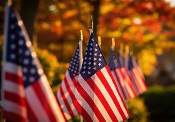 Close-up of several american flags waving in the sun, with a blurred background.