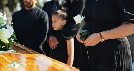 Hand, flower and woman by coffin for funeral ceremony, grief and memorial service outdoor with...