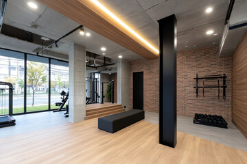 Modern fitness studio showcasing a spacious workout area with various equipment and sleek design elements