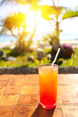 Orange Fruit shake cocktail with ice and straw in it, tropical vacation. Summer holidays