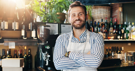 Man, barista and arms crossed with smile at cafe with pride, confident and business owner at bar. Person, happy and portrait with job at pub, catering and entrepreneurship at coffee shop in Turkey