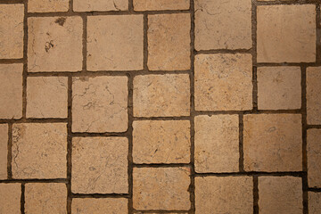 Paving surface. Orange square tiles texture. Stone street road - paving texture effect
