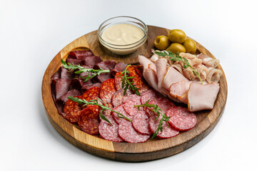 Wooden plate with sausages, ham, salami 