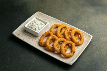 Fried onion rings with tzatziki sauce