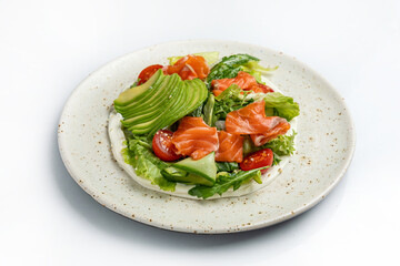 salad with salmon and cherry tomatoes on a white background in the restaurant