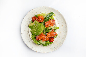 salad with salmon and cherry tomatoes on a white background in the restaurant