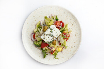 salad with feta cheese and vegetables on a white background in the restaurant