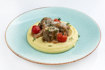 Grilled fillet with french fries and sauce on a wooden plate