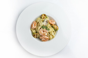 Tagliatelle pasta with shrimp and zucchini on white plate