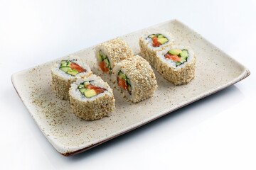 Sushi roll with salmon, avocado and cucumber on white background