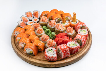 Sushi roll with salmon, avocado and cucumber on white background