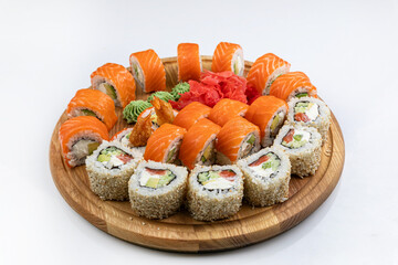 Sushi roll with salmon, avocado and cucumber on white background
