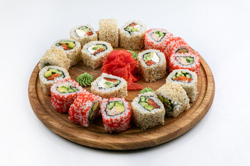 Sushi roll with salmon, avocado and cucumber on white background