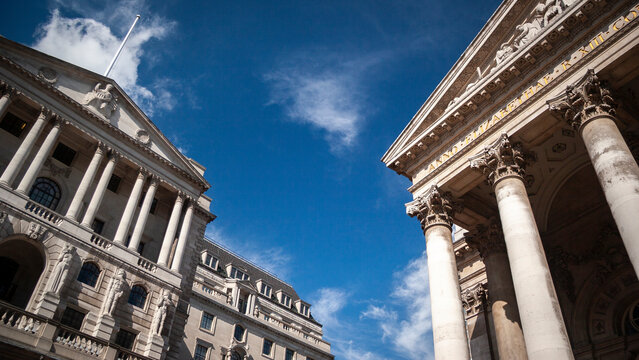 British Financial Institutions. A low, wide-angle view to the facade to the iconic Bank of England building and Royal Exchange in the heart of The City of London's financial district.