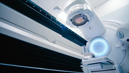 Empty radiotherapy treatment room with linear accelerator ready for use. The clean, modern medical...