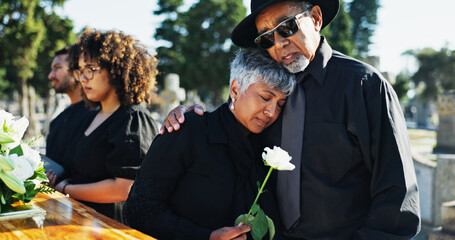 Embrace, sad and funeral with people, graveyard and grief with emotion, empathy and sorrow....