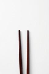 Obraz premium Sleek, dark wood chopsticks isolated on pure white , wood, dinner, culture