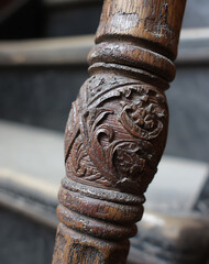 Fototapeta premium Closeup of Ornate Brown Wooden Banister with Intricate Floral Carving