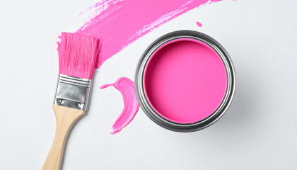 Metal can with pink paint and brush. Flat lay on white backdrop.