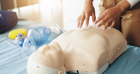 Hands, person and explaining cpr with dummy for demonstration, compression and breathing safety. Woman, mannequin and ventilation process of medical emergency, healthcare protocol and technique steps
