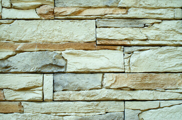 New yellow cladding tiles imitating stones closeup