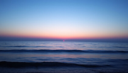 Fototapeta premium Twilight Over a Calm Ocean: Horizon with Gentle Waves