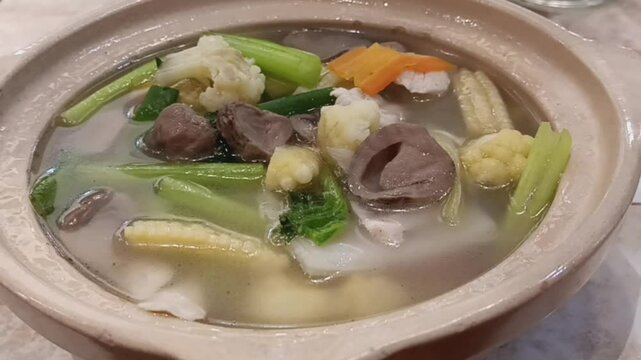 Cap cay kuah is a Chinese Indonesian stir fried assorted vegetables mixed with chicken, fish cakes and fish balls in soup served in a claypot.