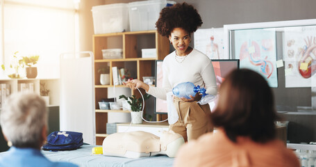 Healthcare, training and woman with mask, dummy and lesson to help in emergency, cpr and demonstration. Course, people and instructor with ventilator for mannequin, breathing and oxygen in class