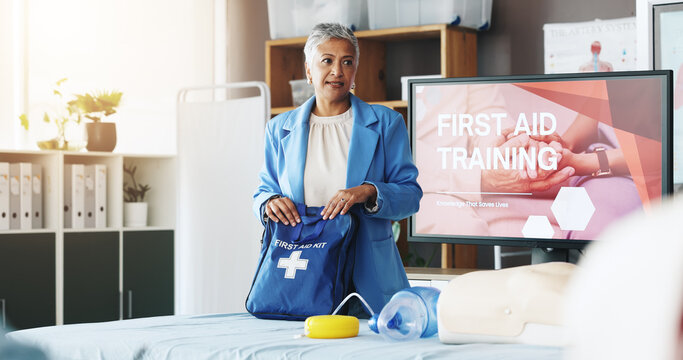 Woman, teaching and bag for first aid training for rescue safety, demonstration lesson and advice. Person, explain and injury kit for medical emergency, learning procedure and process for life saving