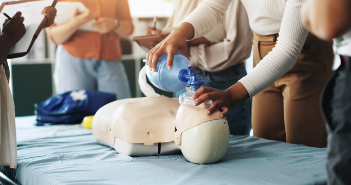 Group, cpr and woman with mask, dummy and lesson to help in emergency, training and demonstration. Course, people and instructor with ventilator for mannequin, teaching and healthcare in class - Powered by Adobe