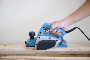 Wood electric planer machine isolated on white background. An electric tool planer machine for...
