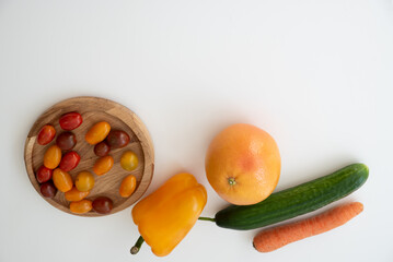 Bright culinary ingredients, vegetables and microgreens are laid out on the table near the wooden...