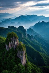 mountains with a few trees on top of them and a cloudy sky