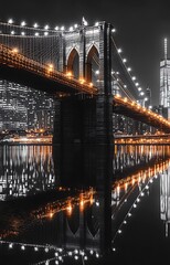 Brooklyn bridge nightscape with city skyline and water reflections in monochrome