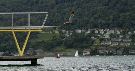 Child diving into the lake from a platform in slow-motion at 800 fps, capturing the thrill and...