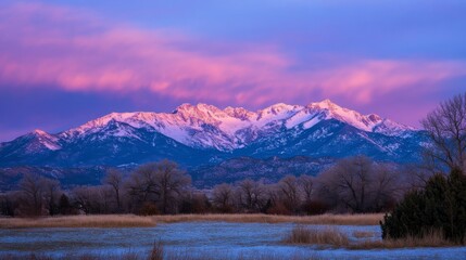 Snow Covered Mountain Range at Sunrise with Pink and Purple Sky