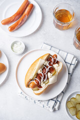 Pickled cucumbers fresh onion frankfurter sausage hot dog sandwich on a white background